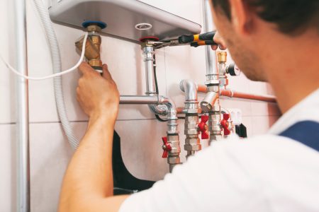 plumber-screwing-nut-pipe-heating-system-boiler-room (1)